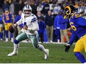 Dallas Cowboys quarterback Dak Prescott looks to pass in the fourth quarter against the Los Angeles Rams in the NFC Divisional Playoff game at Los Angeles Memorial Coliseum on Jan. 12, 2019 in Los Angeles.