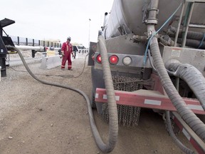 A worker fills his truck at the Shell Sunset water hub for the Groundbirch Saturn natural gas plant outside of Fort St. John, B.C.,  on Oct. 11, 2018. (The Canadian Press)