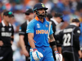 India's Virat Kohli reacts after losing his wicket during a Cricket World Cup semifinal game against New Zealand in Manchester, England, on July 10, 2019. (LEE SMITH/Reuters)