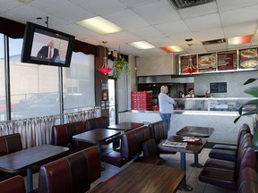 As the Toronto Mayor debate was held in downtown, a TV image of Mayor Rob Ford plays in his favourite spot Steak Queen on Rexdale Blvd in Etobicoke  near where he was filmed in a Jamaican rant months ago on Wednesday March 26, 2014. (Michael Peake/Toronto Sun)