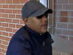 An image released by Halton police of a suspect in an alleged credit-card fraud scheme targeting a Milton condo building.