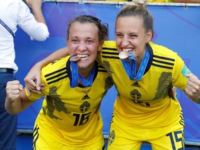 Sweden's Nathalie Bjorn and Julia Zigiotti pose with their medals after the match third-place match against England on July 6, 2019.