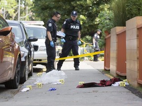 Toronto Police at the scene near Queen St. W. and Ossington Ave. where three men were shot early Monday July 8, 2019. (Stan Behal/Toronto Sun)