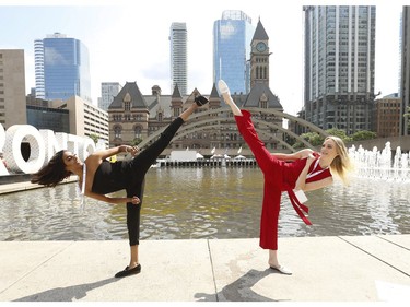 Miss World Canada 2019 delegates Andrea Jerom of Toronto (L) and Victoria Berndt of Georgetown do some kung fu high kicks at Nathan Phillips Square on Wednesday July 24, 2019. Jack Boland/Toronto Sun/Postmedia Network