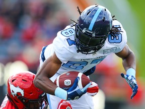 Argos’ Derel Walker is tackled by Stamps’ DaShaun Amos during Toronto’s Week 6 loss in Calgary. (AL CHAREST/POSTMEDIA NETWORK)