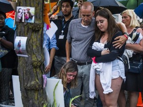 Claudine deBeaumont, Doug Fallon and Quinn Fallon — mother, father and sister of Reese Fallon, one of two people killed in last year's Danforth shootings. The three are standing by the tree where the 18-year-old lost her life at Alexander the Great Parkette near Logan Ave. and Danforth Ave. on Monday July 22, 2019 — the one-year anniversary of the deadly attack.