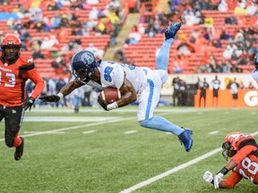 Argonauts’ James Wilder Jr. gets some air as he is tackled by Stampeders’ Brandon Smith on Thursday night at McMahon Stadium in Calgary. (Azin Ghaffari/Postmedia Network)