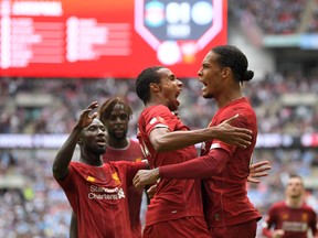 Liverpool defender Virgil Van Dijk (right) looks to lead his club to its first Premier League title. (GETTY IMAGES)