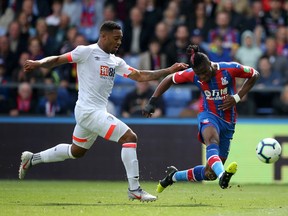 Crystal Palace's Wilfried Zaha takes a shot in front of a Bournemouth defender. (GETTY IMAGES)