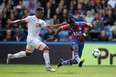 Crystal Palace's Wilfried Zaha takes a shot in front of a Bournemouth defender. (GETTY IMAGES)