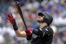 Josh Donaldson #20 of the Atlanta Braves watches his solo home run during the second inning against the New York Mets at Citi Field on August 25, 2019 in New York City. (Photo by Adam Hunger/Getty Images)