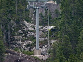 A gondola car rests on its side on the mountain after a cable snapped on Aug. 10 at the Sea to Sky Gondola causing cable cars to crash to the ground. (THE CANADIAN PRESS)