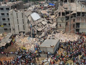 In this photograph taken on April 25, 2013 Bangladeshi volunteers and rescue workers are pictured at the scene after an eight-storey building collapsed in Savar, on the outskirts of Dhaka. Bangladesh authorities said February 10, 2014 they have failed to identify 112 victims of the Rana Plaza factory collapse, almost a year after one of the world's worst industrial tragedies.