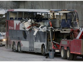 The OC Transpo bus involved in Friday's crash at Westboro Station was towed from the scene, revealing extensive damage, on Jan. 12, 2019. (David Kawai)