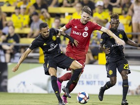 Aug 17, 2019; Columbus, OH, USA; Columbus Crew SC midfielder Artur (8) and Toronto FC forward Patrick Mullins (13) battle for the ball in the second half at MAPFRE Stadium. Mandatory Credit: Greg Bartram-USA TODAY Sports ORG XMIT: USATSI-401758