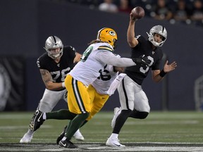 Oakland Raiders quarterback Nathan Peterman (3) is pressured by Green Bay Packers defensive end James Looney (99) in the second half at Investors Group Field Aug 22, 2019 in Winnipeg. Kirby Lee-USA TODAY