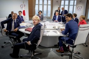 President of the European Council Donald Tusk, Italian Prime Minister Giuseppe Conte, Britain’s Prime Minister Boris Johnson, Japanese Prime Minister Shinzo Abe, President Donald Trump, Canadian Prime Minister Justin Trudeau, French President Emmanuel Macron, and German Chancellor Angela Merkel, participate in a G-7 Working Session on the Global Economy, Foreign Policy, and Security Affairs the G-7 summit in Biarritz, France August 25, 2019. Andrew Harnik/Pool via REUTERS