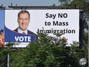 A billboard featuring the portrait of People's Party of Canada (PPC) leader Maxime Bernier and its message "Say NO to Mass Immigration" in Toronto, Ontario, Canada August 26, 2019.
