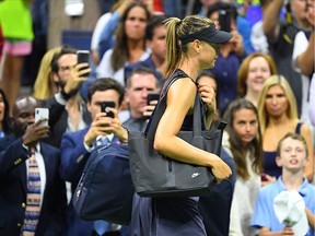 Maria Sharapova of Russia walks off the court after losing to Serena Williams of the USA in the first round on day one of the 2019 U.S. Open tennis tournament at USTA Billie Jean King National Tennis Center. (Robert Deutsch-USA TODAY Sports)