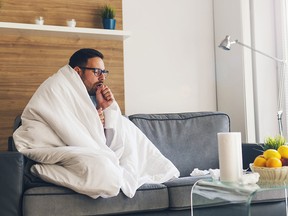 Young man suffering from flu and coughing. (Getty Images)