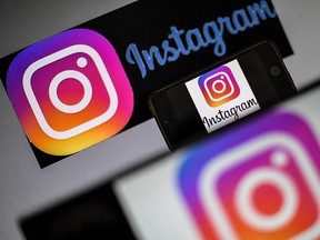 Logos of US social network Instagram are displayed on a screen of a smartphone in Nantes, western France. - Instagram on August 15, 2019 added a way for users to easily report deceptive posts at the photo and video-oriented social network owned by Facebook.A new tool being rolled out out lets Instagram users tap a "report" option on-screen when they see a post they deem dubious, then tap a "false information" tag to prompt review by third-party fact-checkers, according to Facebook spokeswoman Stephanie Otway. (LOIC VENANCE/Getty Images)