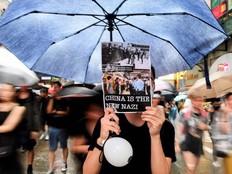Protesters walk along a street during a rally in Hong Kong on August 18, 2019, in the latest opposition to a planned extradition law that has since morphed into a wider call for democratic rights in the semi-autonomous city. - Hong Kong democracy activists gathered August 18 for a major rally to show the city's leaders their protest movement still attracts wide public support despite mounting violence and increasingly stark warnings from Beijing.