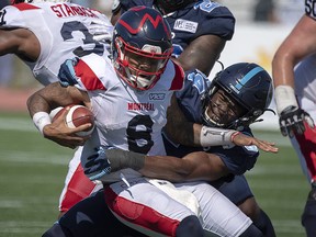 Montreal Alouettes quarterback Vernon Adams Jr. is tackled by Toronto Argonauts Kennan Gilchrist, right, in Moncton, N.B. on Sunday, Aug. 25, 2019. (THE CANADIAN PRESS/Andrew Vaughan)
