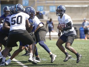 Argonauts running back Brandon Burks looks for a hole at the line of scrimmage during a team practice in advance of Monday’s Labour Day game in Hamilton against the Ticats.  Jack Boland/Toronto Sun