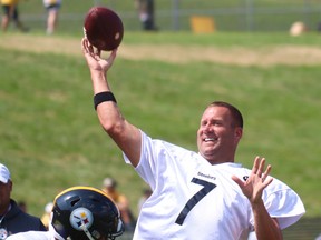 Pittsburgh quarterback Ben Roethlisberger is all smiles as he throws a ball during an NFL training camp.
