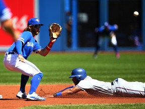 Elvis Andrus of the Texas Rangers steals second base against Bo Bichette of the Blue Jays at Rogers Centre on August 14, 2019 in Toronto. (Vaughn Ridley/Getty Images)