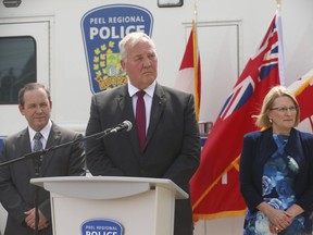 Minister of Border Security and Organized Crime Reduction Bill Blair (podium), Toronto's former chief of police, announced a $54 million infusion over three years starting in 2020 to support Ontario's Guns, Gangs and Violence Reduction Strategy (GGVRS) on Monday, Aug. 26, 2019. With him were Ontario's Attorney General Doug Downey (R) and Ontario Solicitor General Sylvia Jones (L). (Jack Boland/Toronto Sun/Postmedia Network)