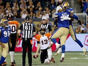 Blue Bombers defensive tackle Drake Nevis celebrates his sack of B.C. Lions quarterback Mike Reilly with teammate Jonathan Kongbo during CFL action in Winnipeg on Thurs., Aug. 15, 2019. (Kevin King/Postmedia Network)