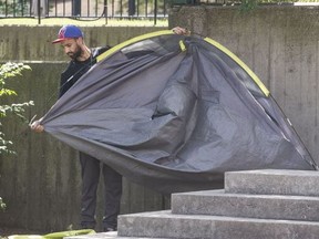 A man takes down his tent on Aug. 12 in a small parkette beside a Park Rd. respite centre. Craig Robertson/Toronto Sun/
