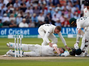 Australia’s Steve Smith lays on the pitch after being hit in the head by a ball off the bowling of England’s Jofra Archer (unseen) during play on the fourth day of the second Ashes cricket Test match at Lord’s Cricket Ground in London on Saturday. A significant number in the crowd booed Smith. (Getty Images)