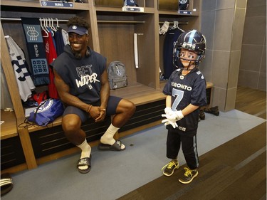 Darius Raso, 7, of Kleinburg, Ont. signed a one-day contract with the Toronto Argonauts was put on the practice roster and poses with Argos James Wilder Jr. .  He was diagnosed and battling acute lymphocytic leukemia for the past year and was out on the field with the Argos. He will also be at the Labour Day Classic in Hamilton. on Thursday August 29, 2019. Jack Boland/Toronto Sun/Postmedia Network