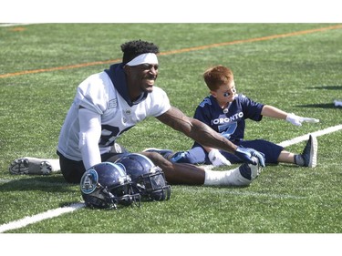 Darius Raso, 7, of Kleinburg, Ont. signed a one-day contract with the Toronto Argonauts was put on the practice roster.  He is out stretching 0n the field with Jame Wilder Jr. (Pictured) He was diagnosed and battling acute lymphocytic leukemia for the past year and was out on the field with the Argos. He will also be at the Labour Day Classic in Hamilton. on Thursday August 29, 2019. Jack Boland/Toronto Sun/Postmedia Network