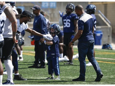Darius Raso, 7, of Kleinburg, Ont. signed a one-day contract with the Toronto Argonauts was put on the practice roster. (Pictured) Raso gets some keep-away moves from wide receiver Dwerel Walker (L).  Raso was diagnosed and battling acute lymphocytic leukemia for the past year and was out on the field with the Argos. He will also be at the Labour Day Classic in Hamilton. on Thursday August 29, 2019. Jack Boland/Toronto Sun/Postmedia Network
