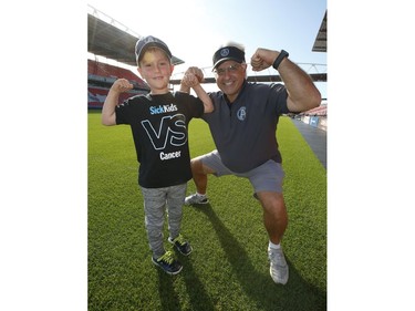 Darius Raso, 7, of Kleinburg, Ont. signed a one-day contract with the Toronto Argonauts and GM Jim Popp (R)  and posed for pictures on the BMO Field. He was diagnosed and battling acute lymphocytic leukemia for the past year and was out on the field with the Argos. He will also be at the Labour Day Classic in Hamilton. on Thursday August 29, 2019. Jack Boland/Toronto Sun/Postmedia Network