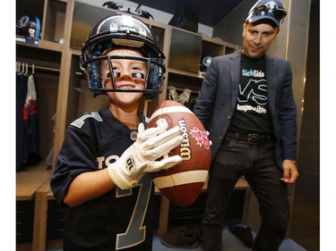 Darius Raso, 7, of Kleinburg, Ont. signed a one-day contract with the Toronto Argonauts was put on the practice roster and poses with his dad Marc.  He was diagnosed and battling acute lymphocytic leukemia for the past year and was out on the field with the Argos. He will also be at the Labour Day Classic in Hamilton. on Thursday August 29, 2019. Jack Boland/Toronto Sun/Postmedia Network