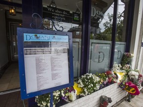 Following a daylight shooting on Friday that claimed the life of Paolo Caputo, flowers are placed outside of Domani Restaurant along Roncesvalles Ave. in Toronto, Ont. on Sunday August 18, 2019. Ernest Doroszuk/Toronto Sun