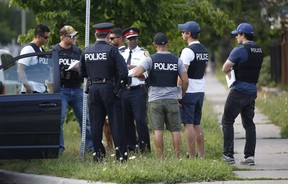 Police chief Mark Saunders speak with officers after a double-shooting in Flemingdon Park on Wednesday, Aug. 7, 2019. (Ernest Doroszuk/Toronto Sun/Postmedia Network)