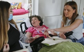 Emmy Simmons, now 28, is seen here with support staff in Wales where her family now lives on Tuesday, July 2, 2019. (Veronica Henri/Toronto Sun/Postmedia Network)