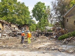 Workers at the site of the natural gas explosion that totally demolished the house at 450 Woodman and almost destroyed the two neighbouring homes in London, Ont. Photograph taken on Friday, Aug. 16, 2019. (Mike Hensen/The London Free Press/Postmedia Network)