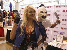 Danielle DeNicola, dressed as Black Canary from DC Comics, poses with Jaiden as Art the Clown from Terrifier at Fan Expo Canada at the Metro Toronto Convention Centre on Thursday August 22, 2019. Jack Boland/Toronto Sun