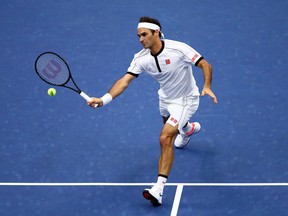 Switzerland’s Roger Federer returns a shot against Damir Dzumhur of Bosnia and Herzegovina during their second-round match at the U.S. Open on Wednesday in New York. Federer dropped the opening set before rolling the rest of the way. (GETTY IMAGES PHOTO)