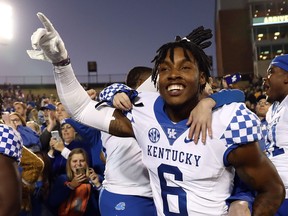 Cornerback Lonnie Johnson Jr. of the Kentucky Wildcats celebrates with teammates and fans after the Wildcats defeated the Missouri Tigers 15-14 to win the game at Faurot Field/Memorial Stadium on Oct. 27, 2018 in Columbia, Miss. (Jamie Squire/Getty Images)