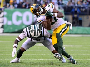 Jamal Adams #33 of the New York Jets tackles Davante Adams #of the Green Bay Packers.Photo by Steven Ryan/Getty Images)