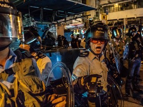Riot police point pepper spray in the direction of protesters during clashes in Sham Shui Po on August 29, 2019 in Hong Kong, China.