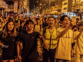 Local residents and protesters shout at police in Sham Shui Po on August 29, 2019 in Hong Kong, China.