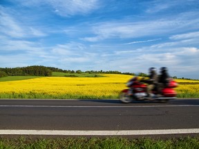 Motion blur red motorcycle speeding on the asphalt road